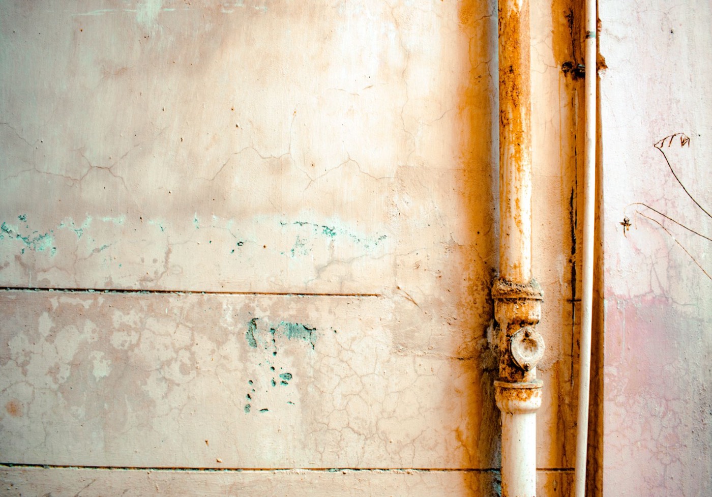Corroded, rust-stained plumbing hidden inside a home